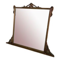 an ornately decorated mirror is shown against a white background