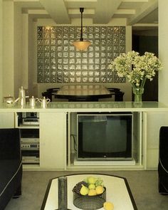 a living room filled with furniture and a flat screen tv sitting on top of a table