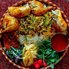 a bowl filled with different types of food on top of a red tablecloth covered floor