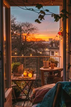 Cozy balcony setup with string lights, plants, and a sunset view, creating a warm, inviting atmosphere. Balcony Eating Spaces, Super Small Balcony Ideas, Small City Balcony, City Balcony Aesthetic, Balcony Rain Aesthetic, Balcony Ideas For Rainy Places, Apartment Porch