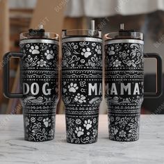 three black and white coffee mugs sitting on top of a marble table with the words dog mama printed on them