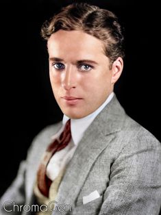 a man in a suit and tie posing for a photo