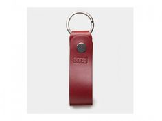 a red leather keychain with an oate logo on the front and back