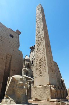 the obelisk and sphinx statues in front of an egyptian temple