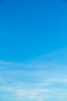 two people standing on the beach flying a kite