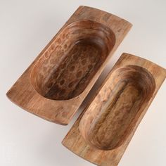 two wooden bowls sitting on top of each other