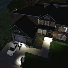 an aerial view of a house at night with cars parked in the driveway and lights on