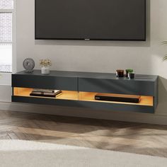 an entertainment center with a flat screen tv mounted on the wall