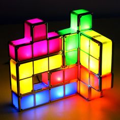 an illuminated rubik cube is shown on a table with the light reflecting off it's sides