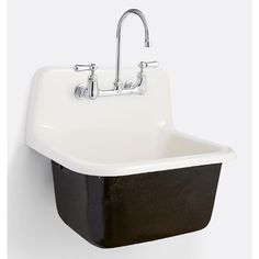 a black and white sink with two faucets on the wall next to it