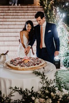 a bride and groom cutting their wedding cake