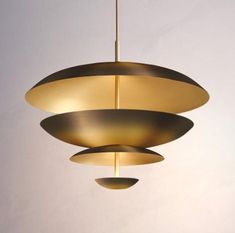 three circular light fixtures hanging from a ceiling