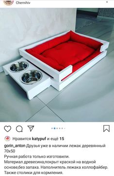 a dog bed with two bowls in it