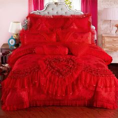 red bedding with ruffles and hearts on the bottom, in a bedroom