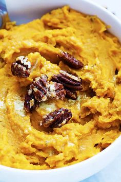 a bowl filled with mashed sweet potatoes and pecans