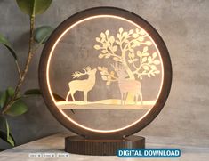 a light up deer and tree in a circle with the words digital download on it