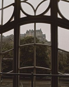 a castle seen through the window of a building