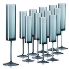 there are many tall glasses lined up together