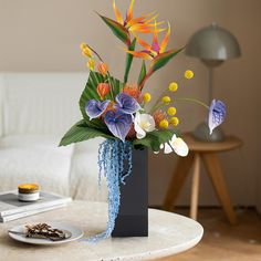 there is a vase with flowers in it on the table