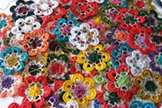 a bunch of colorful flowers sitting on top of a white plate