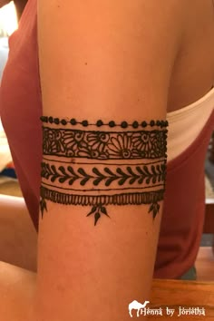 a woman's arm with a hendik tattoo design on the side of her arm