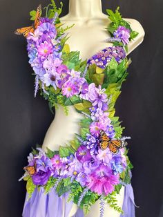 a mannequin with purple flowers and butterflies on it