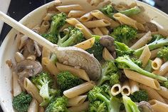 pasta with mushrooms and broccoli in a white bowl