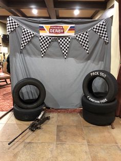 two tires sitting next to each other in front of a banner with checkered flags