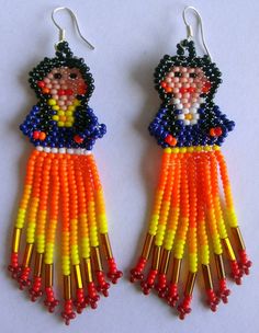 two pairs of beaded earrings with colorful beads on the bottom and one has a woman's face