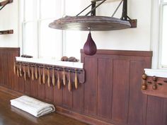 a room with wooden paneling and hanging items