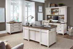 a home office with white furniture and wood floors