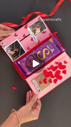 someone is holding an open valentine's day box