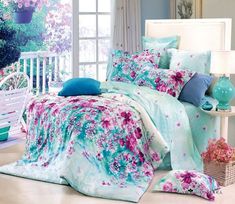 the bed is covered with blue and pink flowers