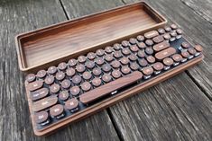 a wooden keyboard sitting on top of a wooden table