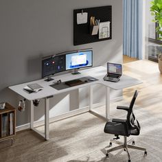 a desk with a computer and laptop on it in front of a wall mounted plant