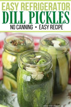 four mason jars filled with pickles and cucumbers