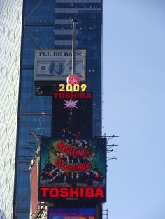 there are many signs on the side of this building that say christmas and toshiba