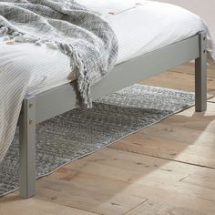 the bed is made up and ready for someone to use it in their home or office