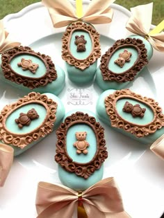 there are chocolates decorated with teddy bears in the shape of frames on a plate