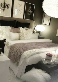 a bed with white sheets and pillows in a bedroom next to pictures on the wall