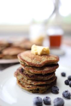 a stack of pancakes with blueberries and butter on top