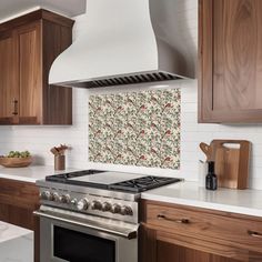 a stove top oven sitting inside of a kitchen next to wooden cupboards and counter tops