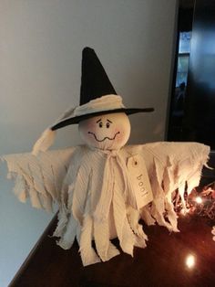 a small scarecrow sitting on top of a table