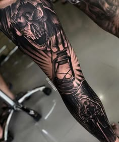 a man's arm with a clock and skull tattoo on the left side of his arm