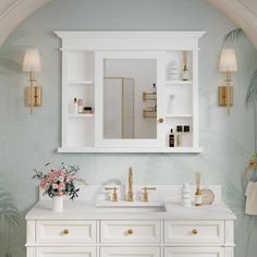 a white bathroom with gold accents and palm leaves on the wall behind the vanity mirror