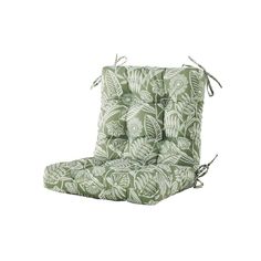 an outdoor chair cushion with green leaves on it