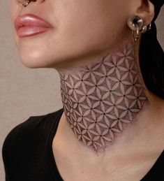 a woman with her neck tattoo designed like a flower of life