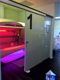 an open door with the number one on it in front of a pink and purple light