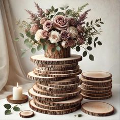 a stack of wooden slices with flowers in the center and some candles on the side