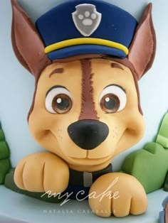 a cake shaped like a dog wearing a police hat